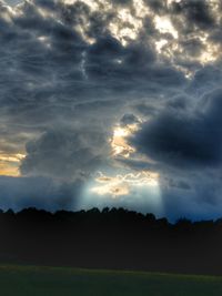 Scenic view of dramatic sky over silhouette landscape