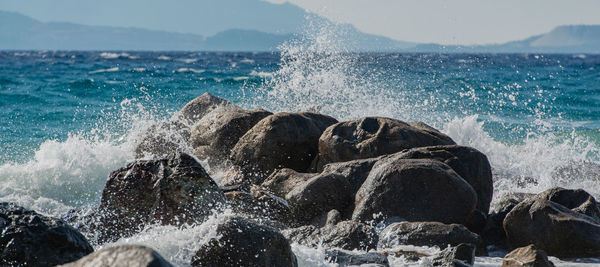 Waves splashing on rocks at shore