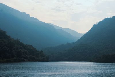 Scenic view of sea and mountains against sky