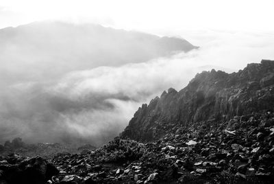 Scenic view of mountains against cloudy sky