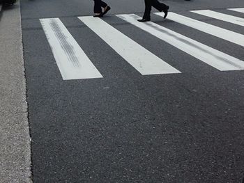 Low section of people walking on road