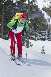 Portrait of woman skiing on snow covered land