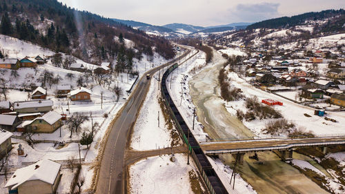 High angle view of snow covered road in city