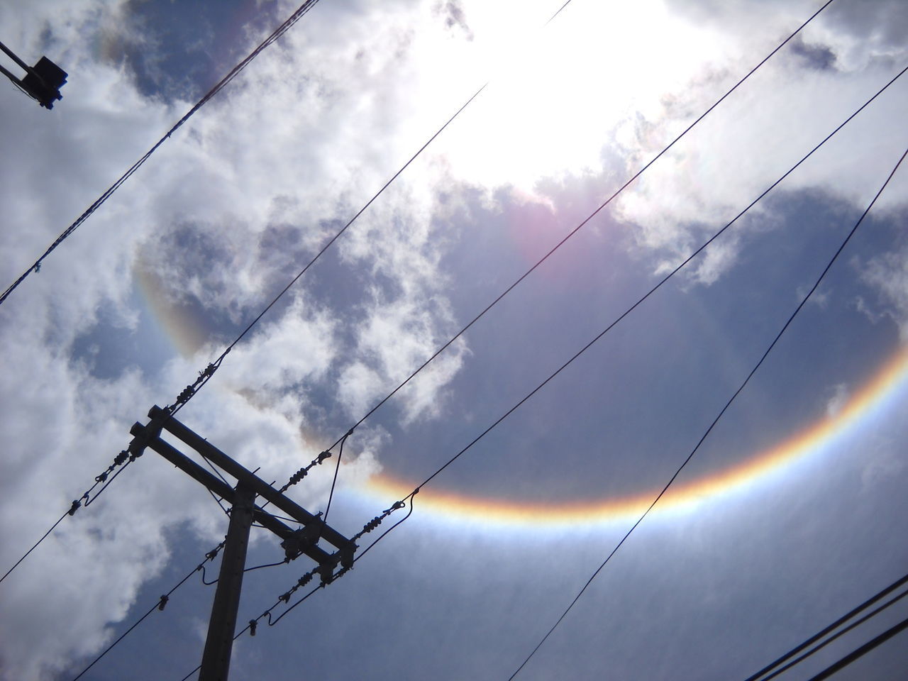 low angle view, cable, power line, connection, sky, electricity, cloud - sky, power supply, cloud, cloudy, electricity pylon, nature, in a row, beauty in nature, day, scenics, tranquility, power cable, tranquil scene, outdoors, no people, multi colored, high section, atmospheric mood, dramatic sky