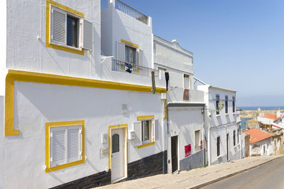 Buildings against clear blue sky