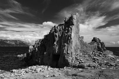 Panoramic view of rocks and sea against sky