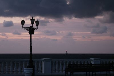 Street light in city against sky