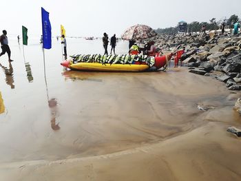 People on beach against sky