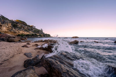 Scenic view of sea against clear sky during sunset