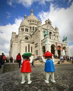 Silhouette people against cloudy sky