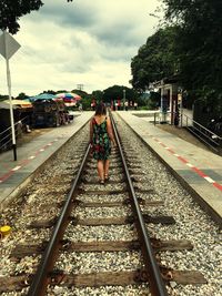 View of railway tracks against cloudy sky