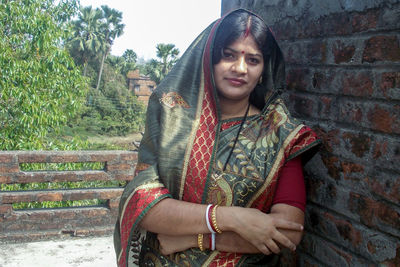 Portrait of smiling young woman sitting outdoors