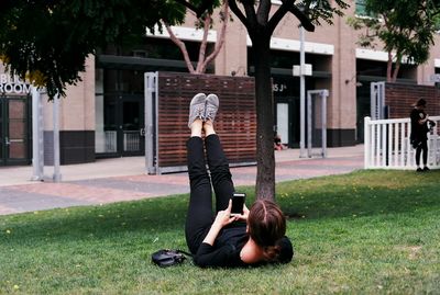 Full length of woman on grass against trees