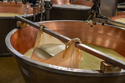 High angle view of machinery in container making cheese 
