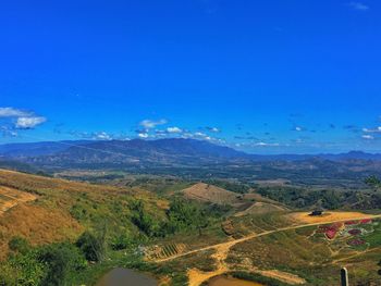 Scenic view of landscape against blue sky