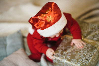 Rear view of woman holding gift