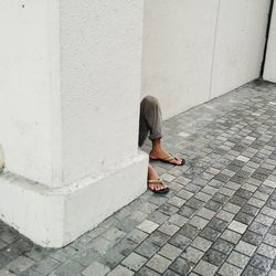 Woman standing on cobblestone
