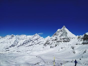 Scenic view of snowcapped mountain against blue sky