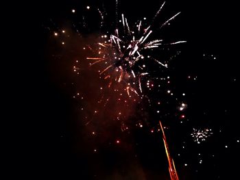 Low angle view of firework display at night