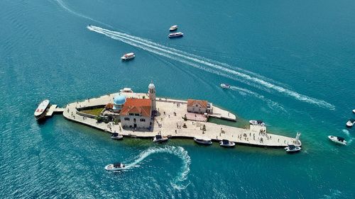 Our lady of the rocks - high angle view of an island and boats in sea