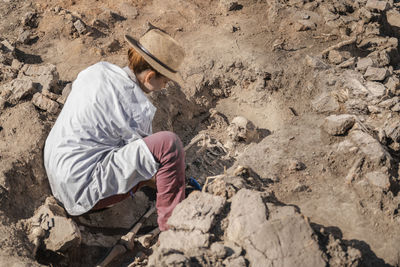 High angle view of man holding rock