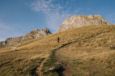 Full length of man walking on land against mountain