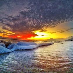 Scenic view of beach against dramatic sky