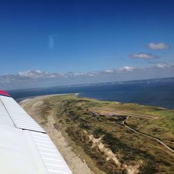 Scenic view of landscape against blue sky