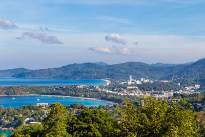 High angle view of city by sea against sky