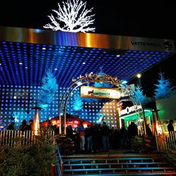 Low angle view of illuminated building against sky at night