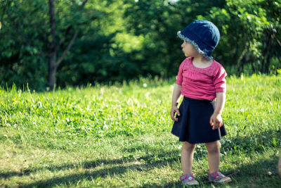 Baby girl standing on grass at park