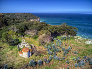 High angle view of trees by sea against sky