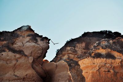 Low angle view of rock formations against sky