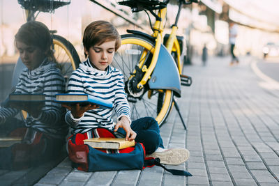 Siblings sitting on wall