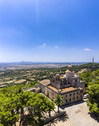 High angle view of buildings against blue sky