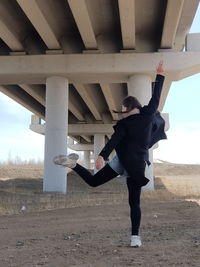 Rear view of woman standing on field