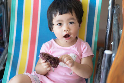 Portrait of cute girl sitting on floor