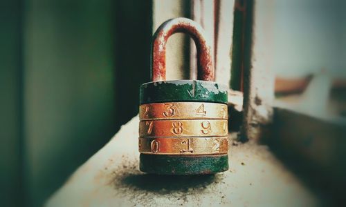 Close-up of padlock on rusty metal