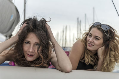 Female friends lying on boat