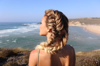 Rear view of woman looking at sea