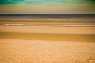 Scenic view of beach against sky during sunset