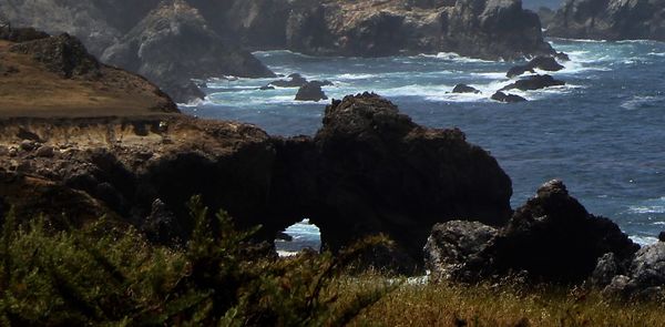 Scenic view of rock formations in sea