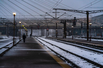 Railroad station platform by street against sky