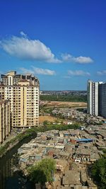 Buildings against cloudy sky