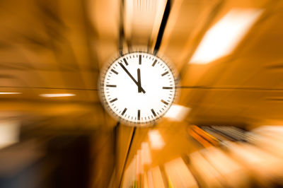 Close-up of clock hanging from ceiling