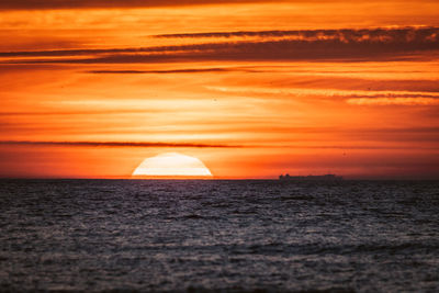 Scenic view of sea against romantic sky at sunset