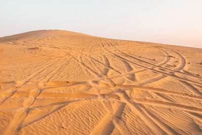 Sand dune in desert against clear sky