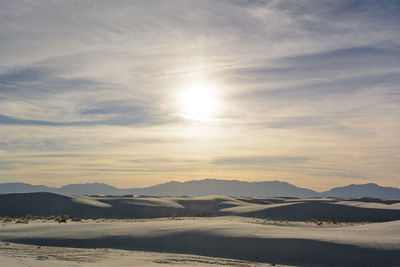 Scenic view of sand dunes during sunset