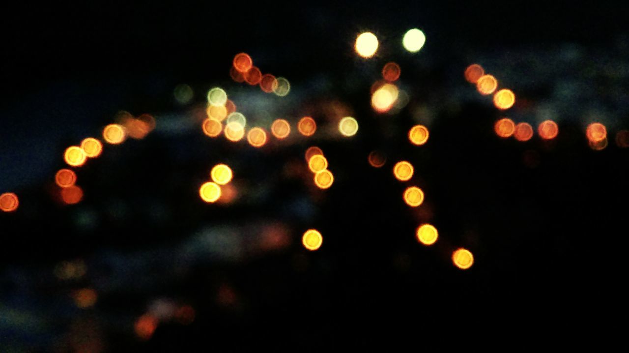 illuminated, night, defocused, circle, multi colored, glowing, lighting equipment, light - natural phenomenon, lens flare, celebration, no people, spotted, outdoors, yellow, pattern, focus on foreground, close-up, orange color, dark, decoration