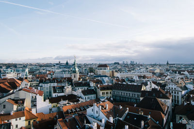 View of cityscape against cloudy sky